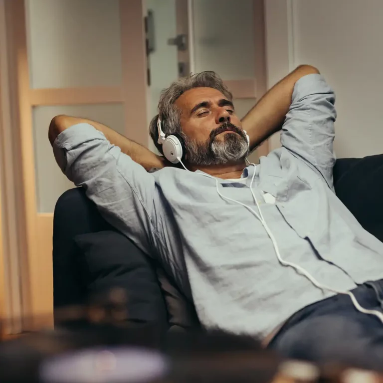 Silk Road NYC - Man Calmly Listening to Music in a Chair