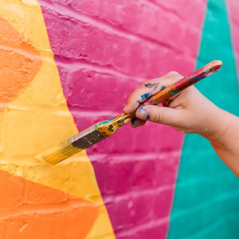 Silk Road NYC - Person Painting a Wall with Bright Colors